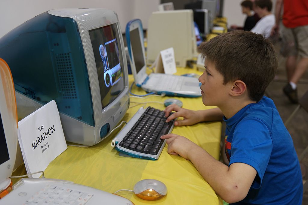 Picture of a child with short brown hair in a blue t-shirt playing on an Imac computer

Credit:https://commons.wikimedia.org/wiki/File:Kid_playing_on_iMac_(16728580353).jpg